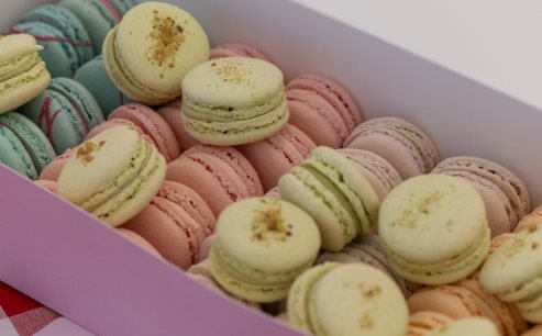 A box of colorful macaroonsDescription automatically generated